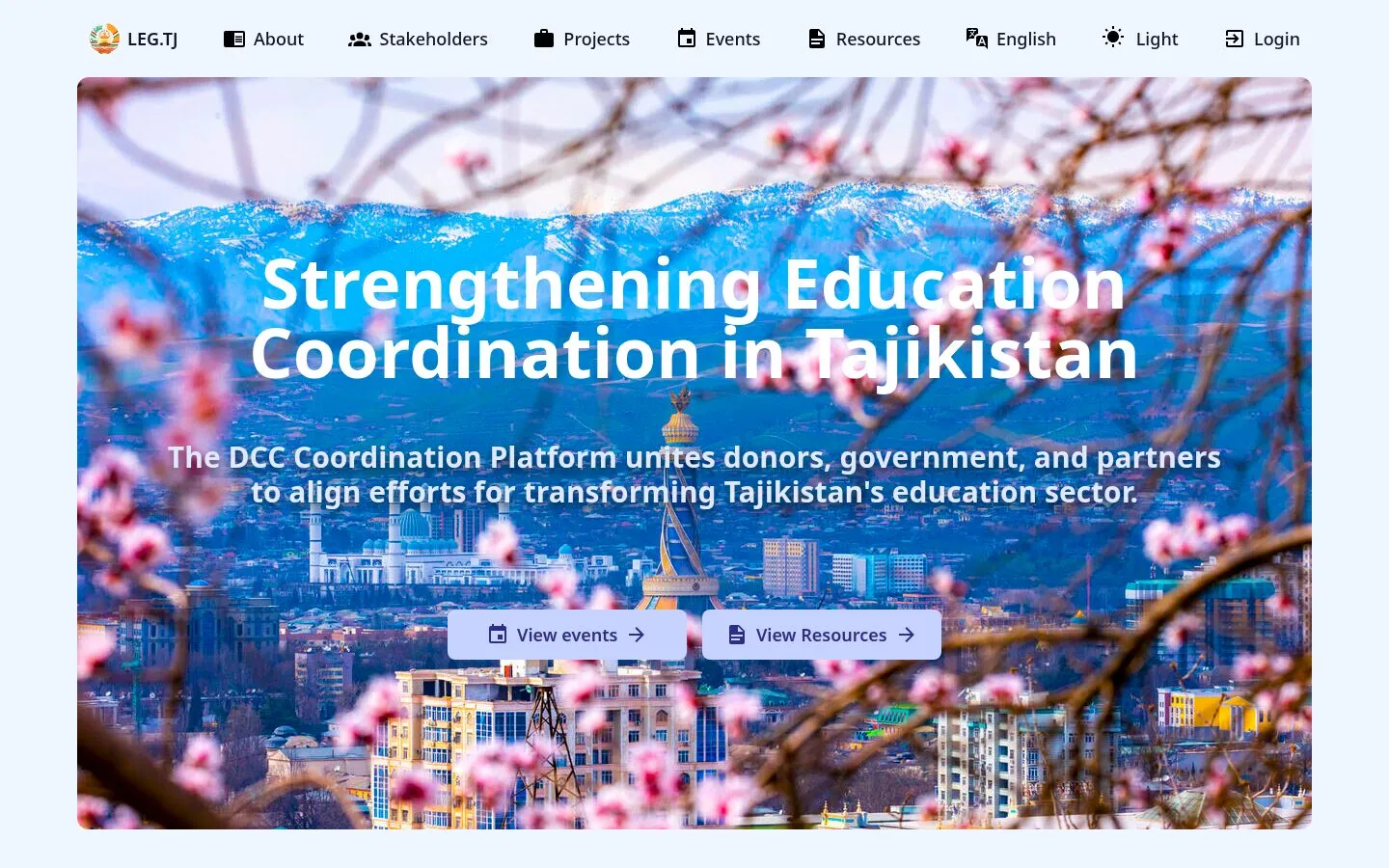 Screenshot of the LEG.TJ marketing homepage hero. Hero photograph shows Dushanbe in spring - snow-capped mountains and a distant cityscape behind blooming pink cherry-blossom branches. White overlaid headline reads "Strengthening Education Coordination in Tajikistan" with the subtitle "The DCC Coordination Platform unites donors, government, and partners to align efforts for transforming Tajikistan's education sector." Two CTA buttons sit centred below: "View events" and "View Resources". Top navigation links: About, Stakeholders, Projects, Events, Resources, English language switcher, light/dark toggle, Login.